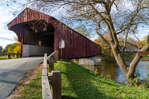 An old red covered bridge over a creek in Indiana.