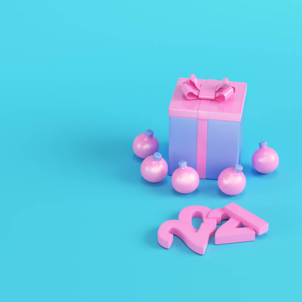 istock Pink Pink present box with christmas baubles and 2021 figures on bright blue background in pastel colors on bright blue background in pastel colors 1281663217