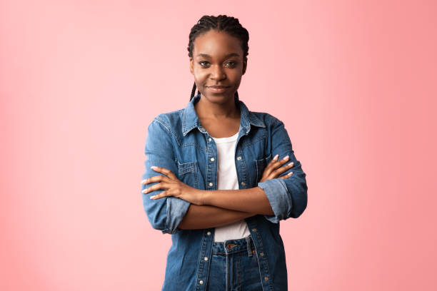 istock Black Young Lady Posing Crossing Hands Standing Over Pink Background 1281663553