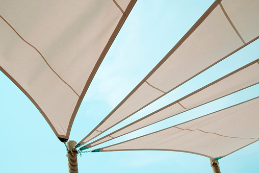 Sun shade sails with sky background.