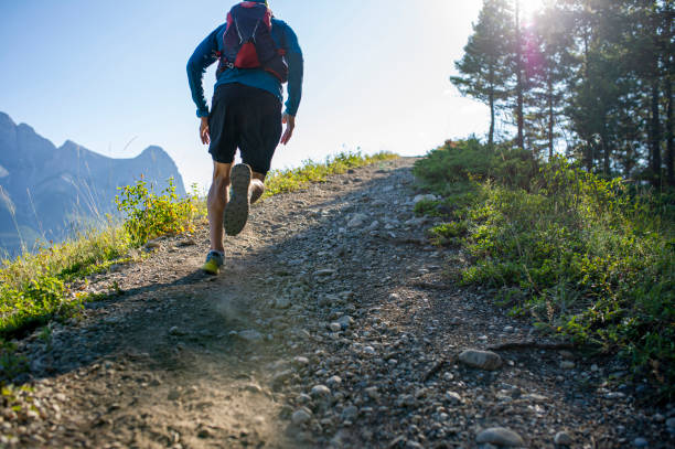 istock Man trail runs along mountain ridge at sunrise 1281664795