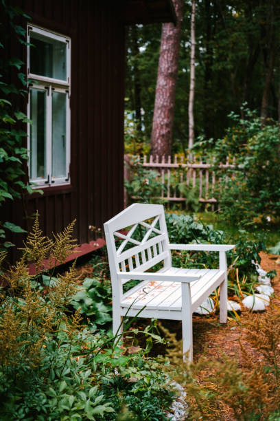 istock Autumn background in village. White bench in a garden. 1281664894