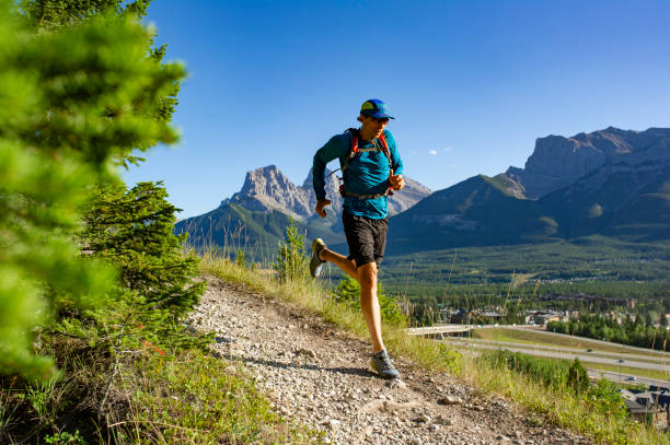 istock Man trail runs along mountain ridge at sunrise 1281665047