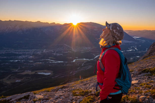istock Woman hikes along mountain ridge at sunrise 1281665959