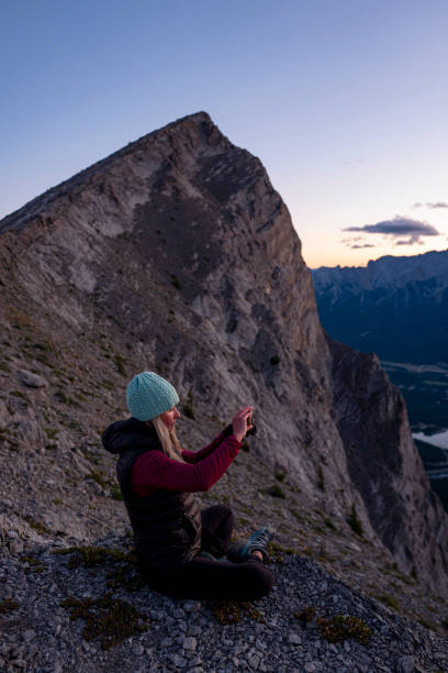 istock Woman hikes along mountain ridge at sunrise 1281667082