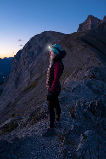 istock Woman hikes along mountain ridge at sunrise 1281667700