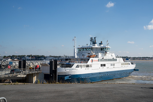 Royan, Charente-Maritime / France - 17 October 2020: the Gironde ferry arrives at the port of Royan to load and transfer vehicles