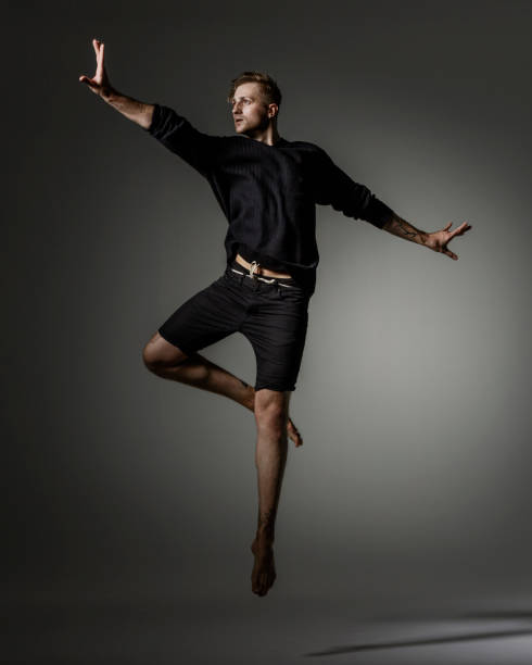 istock Male Dancer jumping on gray background 1281668905