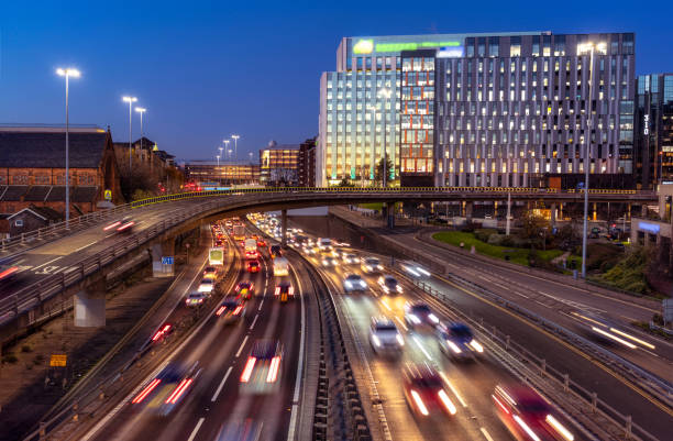 Traffic on the M8 through Glasgow at dusk The M8 busy with commuter traffic at dusk in Glasgow's Charing Cross. glasgow scotland stock pictures, royalty-free photos & images