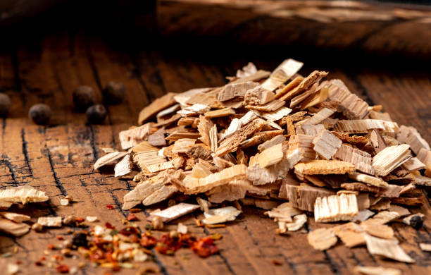 Wood chips for smoking meat close-up. Wood chips for smoking meat or fish on an old wooden table close-up. wood chip stock pictures, royalty-free photos & images