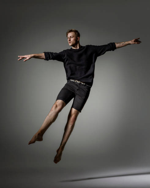 istock Male Dancer jumping on gray background 1281670580