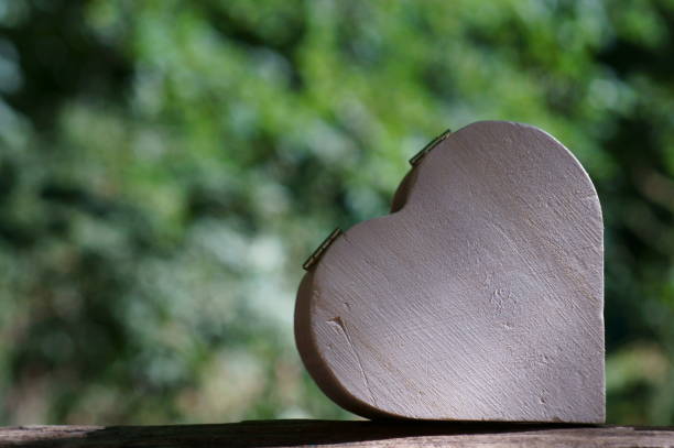 istock Wooden heart in the forest on a colored background. 1281670780