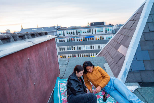 istock Two girlfriends looking on the smartphone an enjoy their time 1281671470
