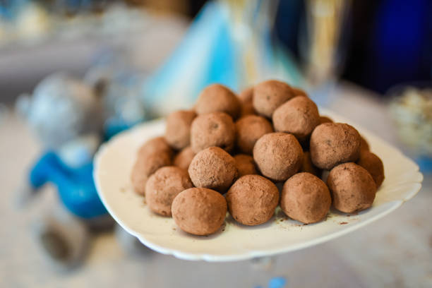 istock Sweet truffles on a plate covered with cocoa. 1281671935