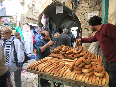 Jerusalem, Israel - 12 09 2018: Arab Palestinian people are shopping at the Jerusalem Old City bazaar market. Arab market is located in Jerusalem Old City - home to several sites of key religious importance.