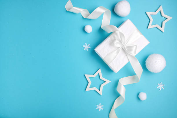 istock Christmas composition, gift box and white balls on blue background, minimalism. 1281674072