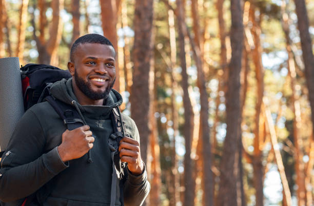 istock African man with backpack hiking by forest 1281674644