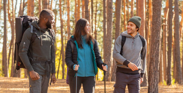 istock Cheerful friends backpacking at countryside, enjoying active weekend 1281674752