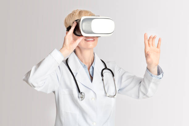 istock Smiling middle aged woman in virtual reality glasses touches empty space 1281674813