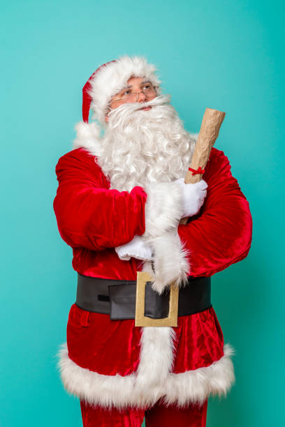 istock Santa holding Christmas presents wish list 1281675028