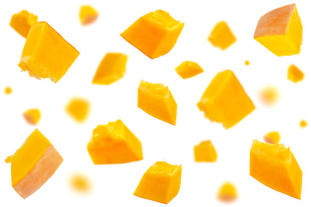 istock Falling pumpkin slices isolated on a white background, selective focus. Pumpkin slices in the air on a white background. Set of pumpkin slices in the air. Pumpkin slices fall. 1281675696