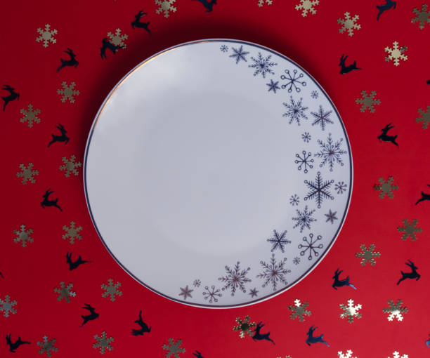 istock Christmas dinner background, plate on a red background surrounded by sequins 1281675942