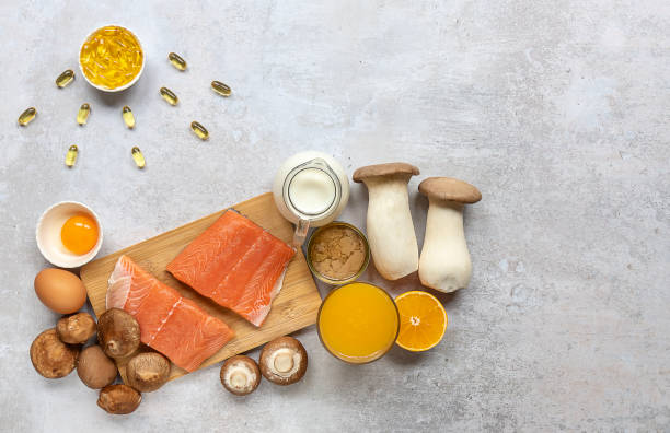 Composition with products rich in vitamin D Flat lay composition with products rich in vitamin D. Canned tuna, mushrooms, salmon, eggs, milk, and orange juice - great natural sources of Vitamin D. Copy space. vitamin d stock pictures, royalty-free photos & images