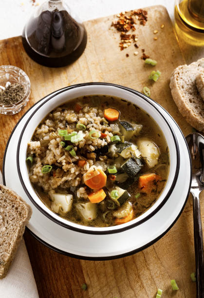 istock vegetable soup with rice and whole grain bread on the table. on a wooden cutting board 1281676438