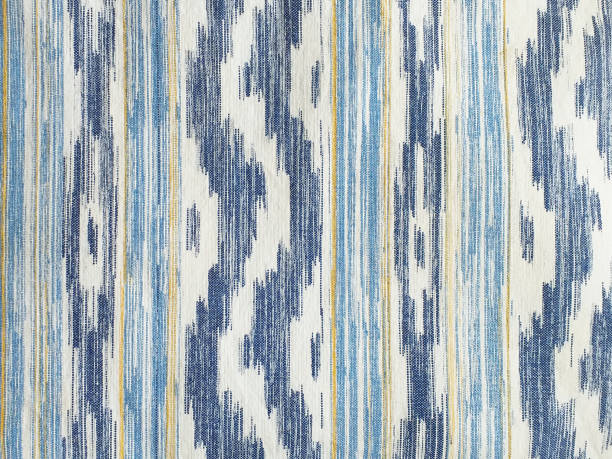 Traditional Mallorcan fabric texture with a pattern in the shape of blue and white tongues. Cushion fabric background made with natural fiber and bluish tint. "IKAT", typical majorcan fabric pattern Traditional Mallorcan fabric texture with a pattern in the shape of blue and white tongues. Cushion fabric background made with natural fiber and bluish tint. "IKAT", typical majorcan fabric pattern. french overseas territory photos stock pictures, royalty-free photos & images