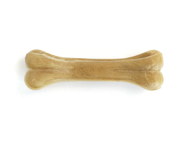 istock Pressed bone shaped Teether for dog puppies isolated on white background. Close up. Pet Dog Toy Teether, Molar Teeth Cleaner, Puppy Dog Toothbrush. Product for the dental care of pets. 1281681793