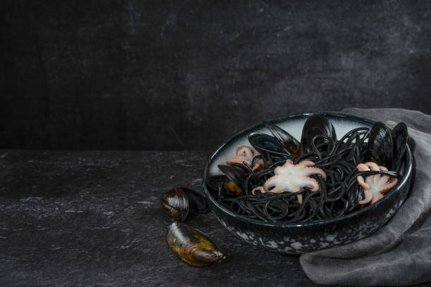 istock Black spaghetti pasta with octopus and mussels 1281682507