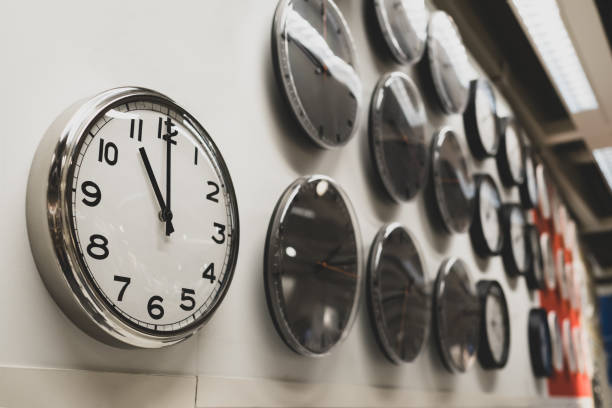 wall clock and decor with many clocks next to it. around the clock.