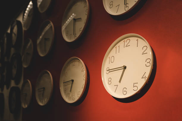 istock time is money concept. White clock on the orange wall. 1281683144