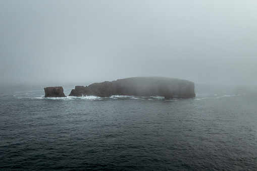 The Dore Holm is a small uninhabited islet off the south coast of Esha Ness, located in the west of Mainland, Shetland, Scotland.