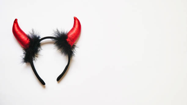 istock Red devil horns head hoop on white background. Accessory for Halloween celebration, top view, flat lay, copy space 1281683442