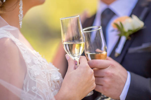 istock Women's and men's hands hold champagne glasses. 1281684147