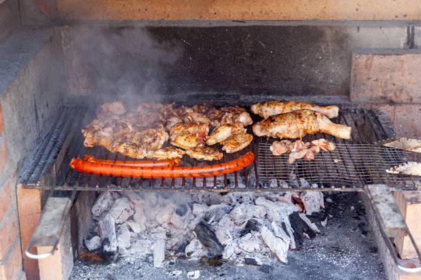 istock Grilling chicken wings, wurst and other meat on barbecue grill 1281684502