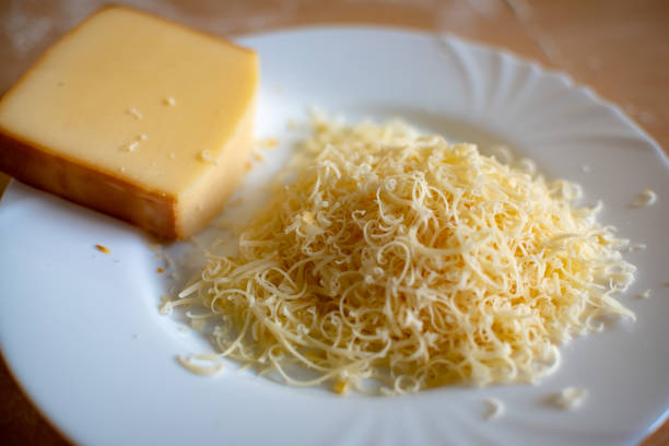 istock Closeup of grated cheese on white plate 1281686342