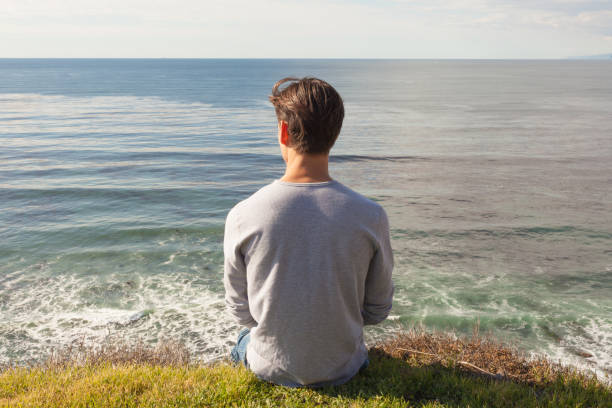 istock Calm young man enjoying a quiet self time at the beach. 1281687626