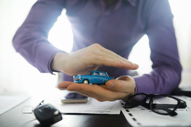 istock The insurance agent signs a document. Car insurance policy. Auto insurance policy. Forms for registration of the contract. 1281687898