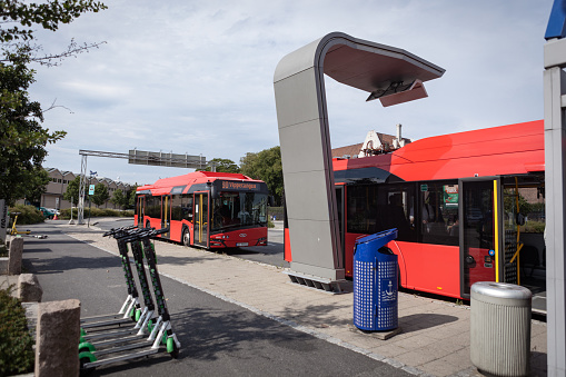Copenhagen, Denmark - May 15, 2023: Scene Of Building Exterior, Public Transportation Bus, People Riding Bicycle, Walking And More During Springtime