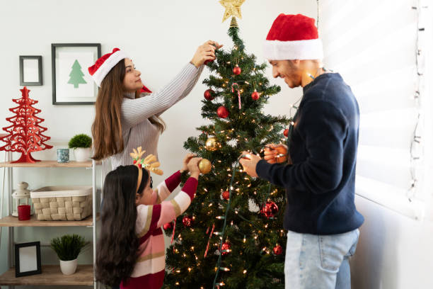 istock Latin family decorating Christmas tree 1281689360