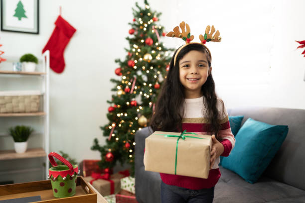 istock Little girl with a Christmas present 1281689504