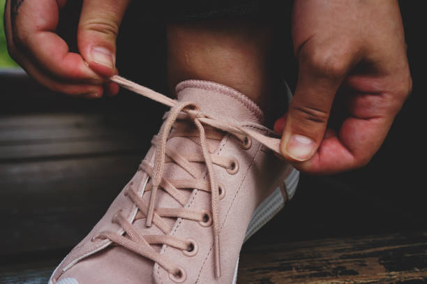 istock girl ties shoelaces 1281690294