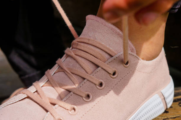 istock girl ties shoelaces 1281690297