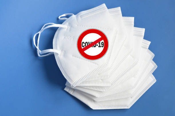 istock Stop covid-19 outbreak around the world. Mask against coronavirus with write and symbol Stop Covid 19. 1281690427