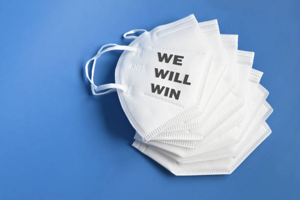 istock WE WILL WIN against covid-19 outbreak around the world. ffp2 mask against coronavirus with write We Will Win and Covid 19 Logo. 1281690430