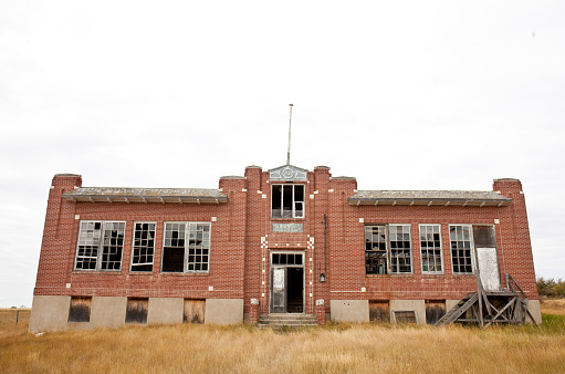 Exterior of old blue and white office building ready for demolition.