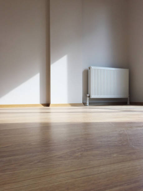 istock New modern home radiator with clean wall and parquet flooring, home interior 1281691475