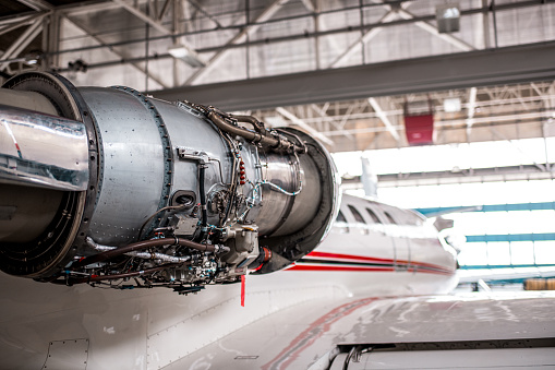 Aircraft Jet engine maintenance in the airplane hangar.